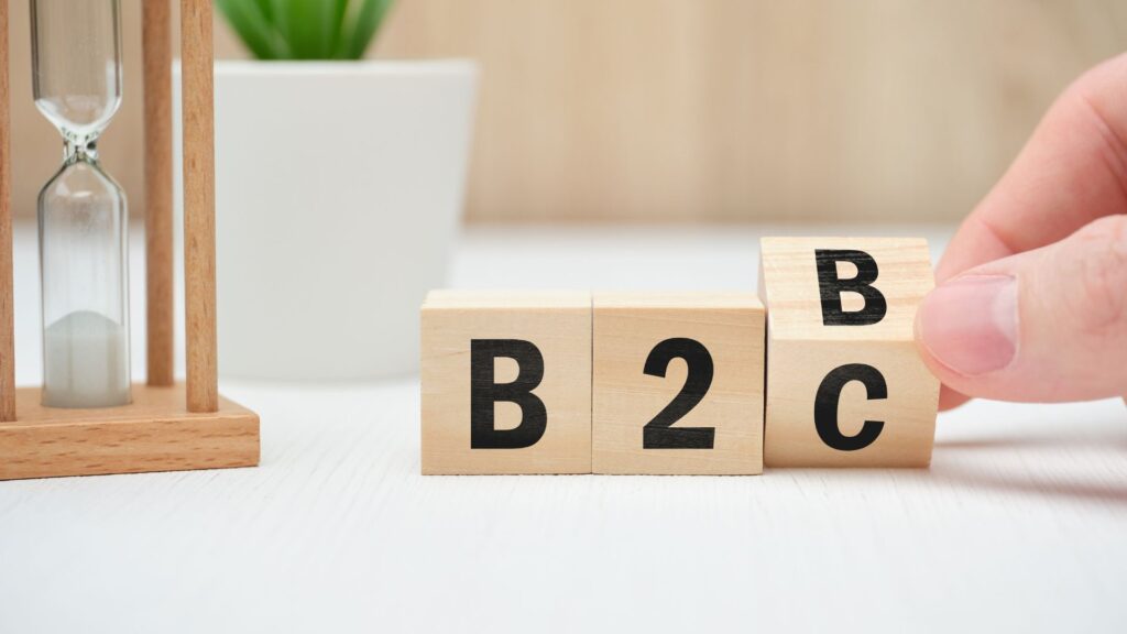 Wooden blocks on tabletop with letters B2B, and the last block being flipped from B to C to represent B2B and B2C marketing.